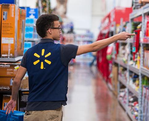 walmart associate scanning items on shelves