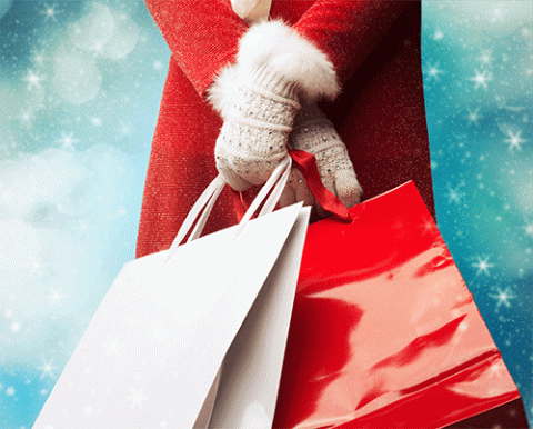 woman holding christmas gift bags