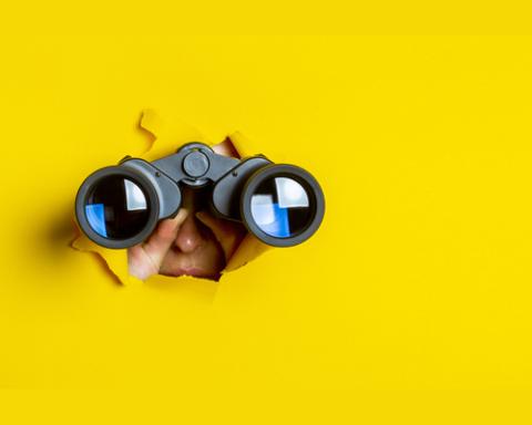 looking through binoculars