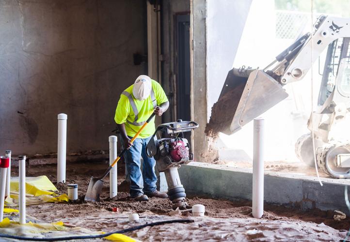 A member of the construction team works inside the Lake Street store.